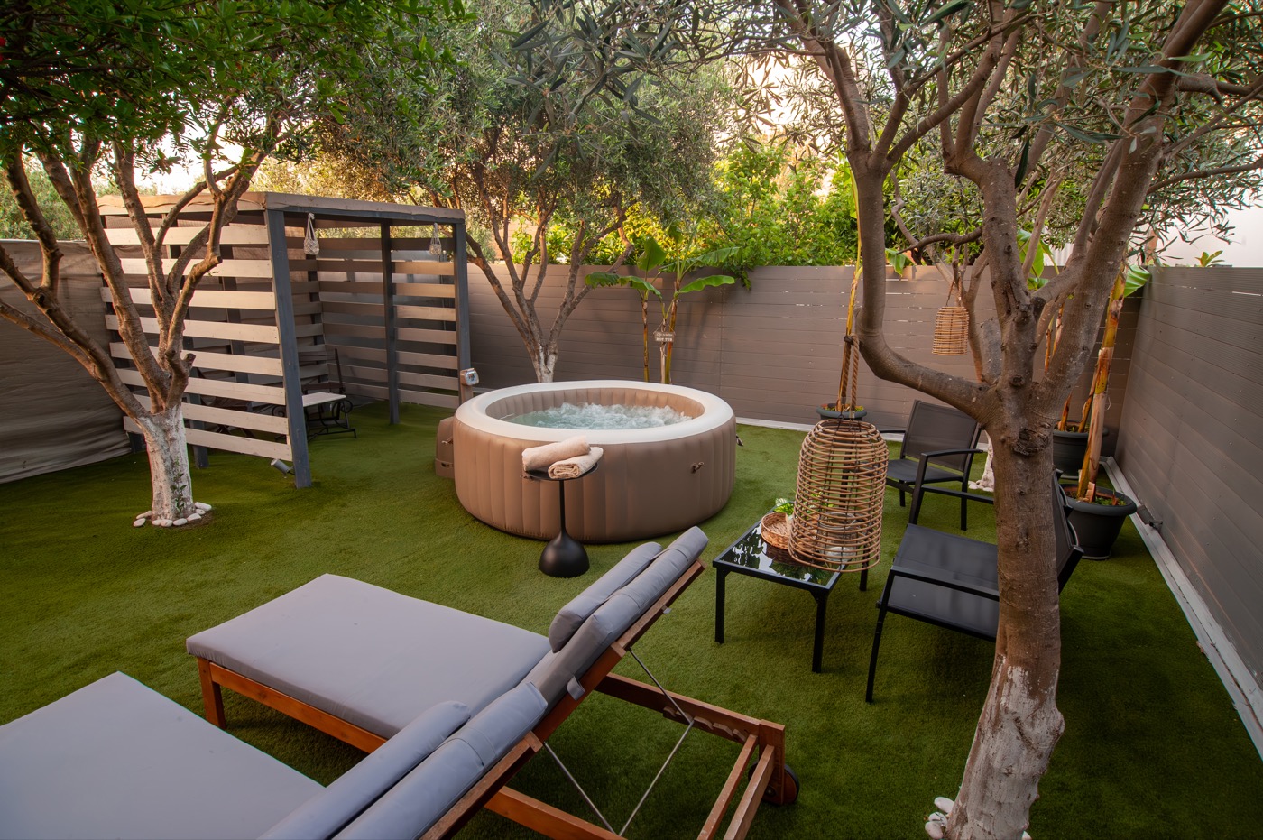 Home Away From Home hot tub and lounge seating at dusk